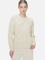 Soft and form-fitting round-neck sweater with diamond-cutout pattern.