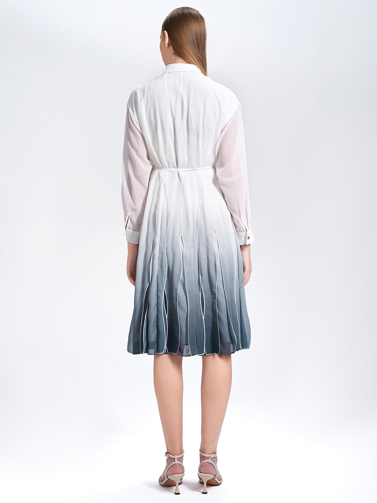 S·DEER shirt dress, emphasizing the minimalist design with pleats that add texture and depth, making it a perfect dress for versatile occasions